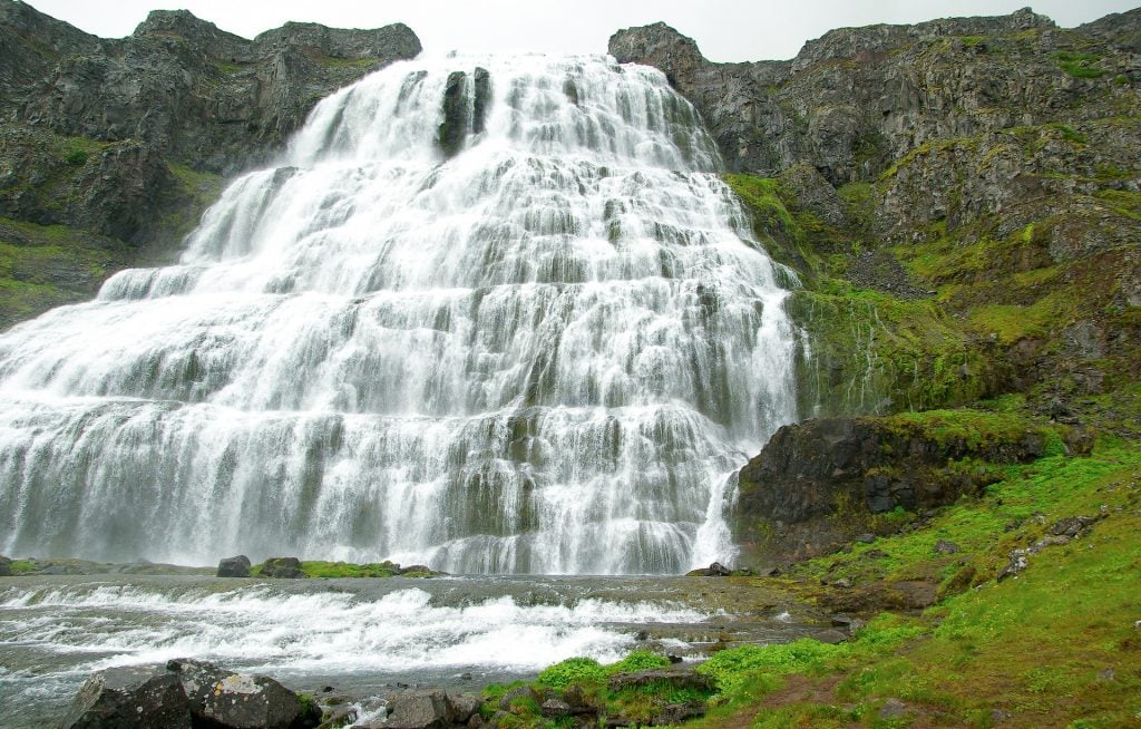 Big cascading waterfalls in rugged Icelandic landscape