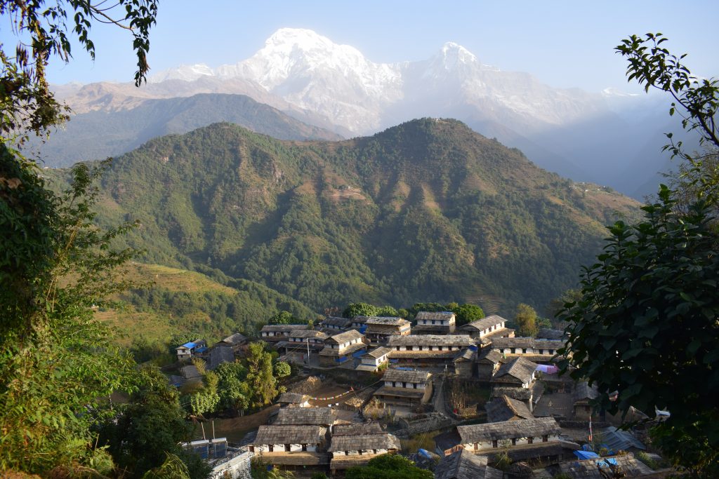 Ghandruk village in Nepal with green mountains in the background.