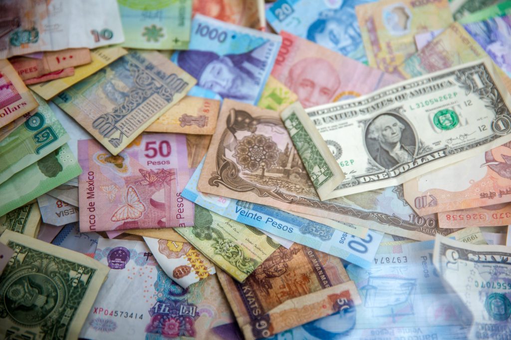 colourful money notes in different currencies.
