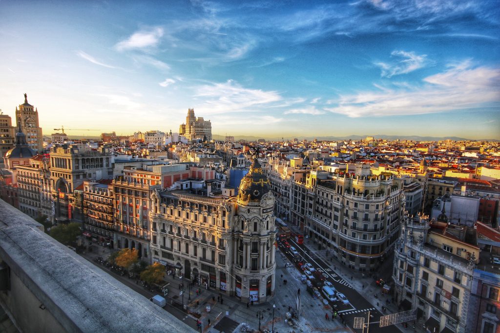 Plan your 2021 travel to Spain, Madrid in the warm sun shining on the buildings. 