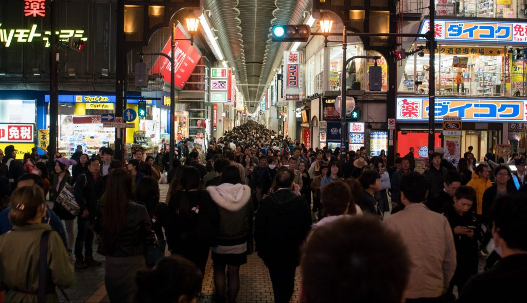 A crown of people in the streets in the night shopping for Black Friday during the pandemic