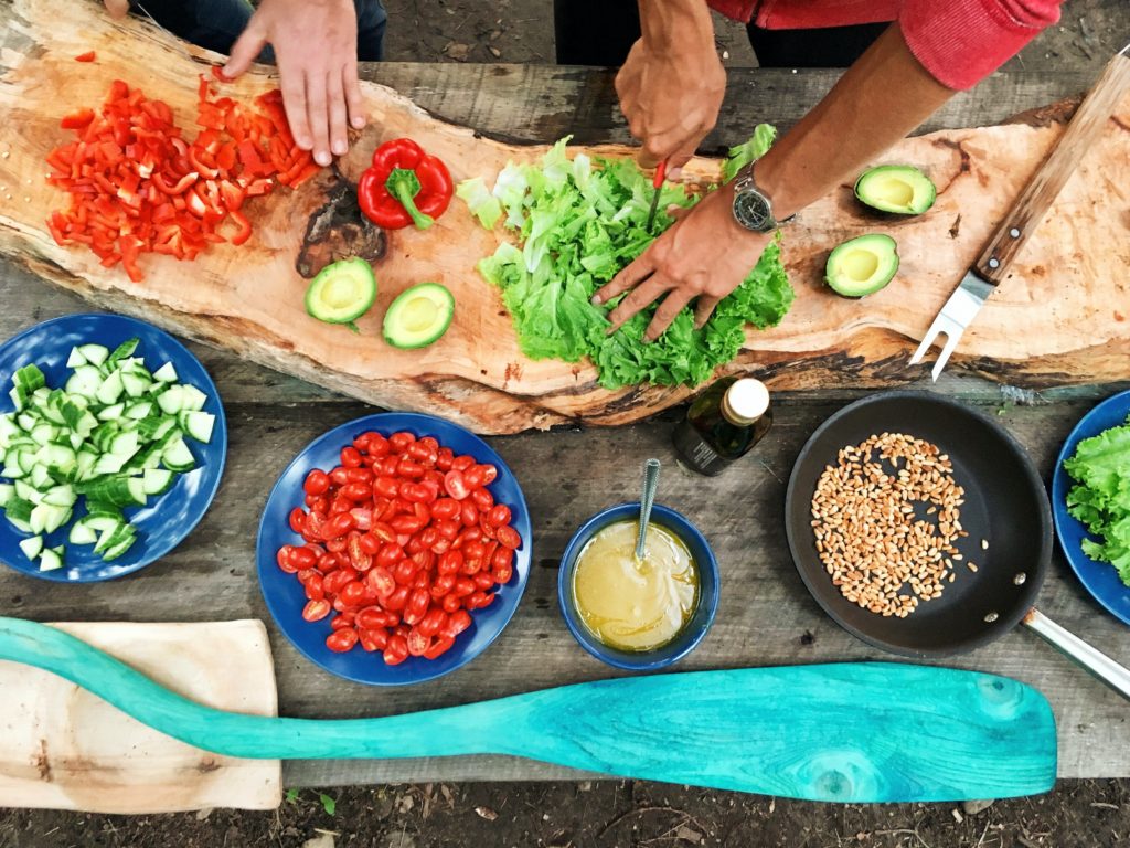 two people are cooking together 