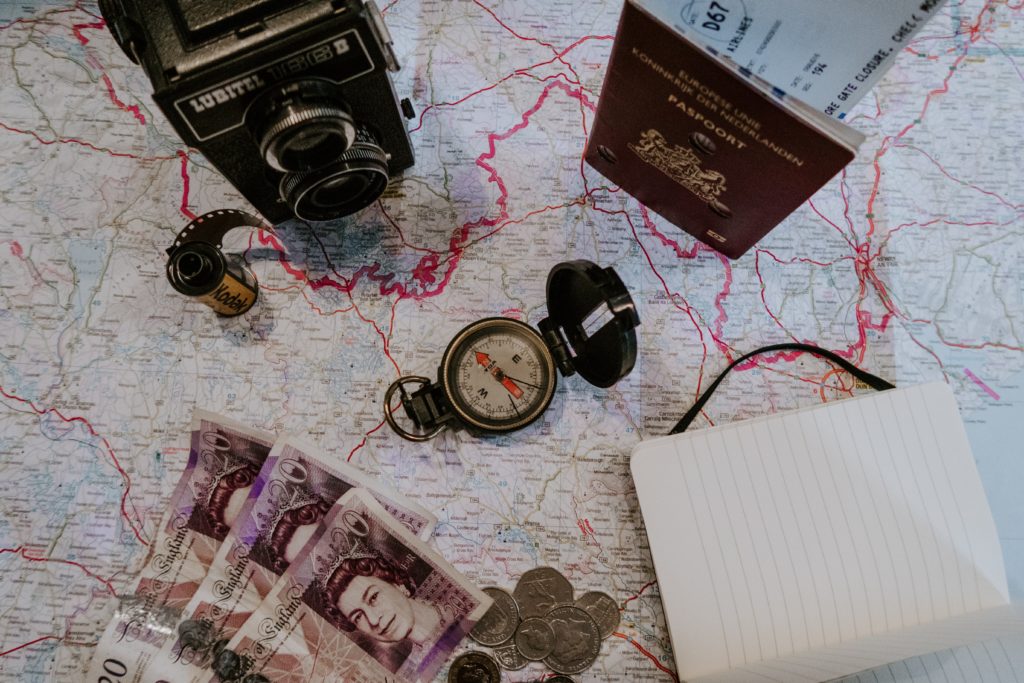 how to be the perfect trip leader - a map on a table with a passport and bank notes 