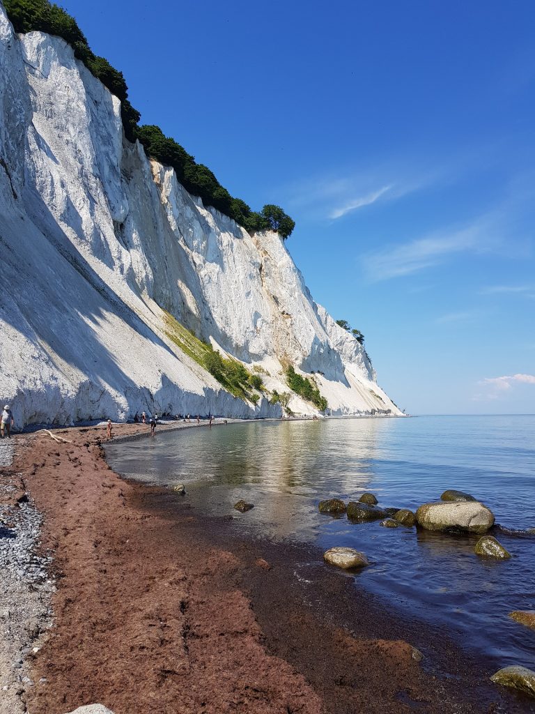 White cliffs of Mons Klint by water on a clear day in Denmark