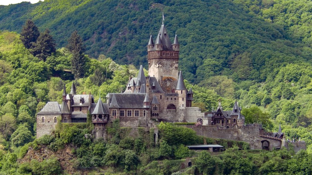 a beautiful landscape of green trees and mountains surround the Reichsburg Cochem in Rhineland-Palatinate