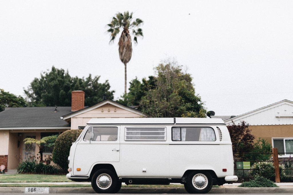 best travel apps a picture of a white camper van in a suburb 