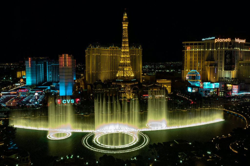 A view of Las Vegas, Nevada in the night with lights everywhere and the fake Eiffel Tower.