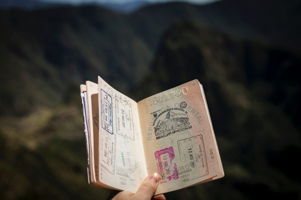 how to be the perfect trip leader - a hand holding a passport 
