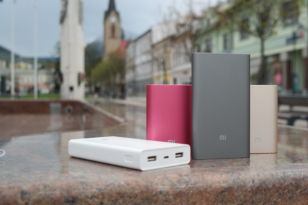 powerbanks in different colours on a bench outside 