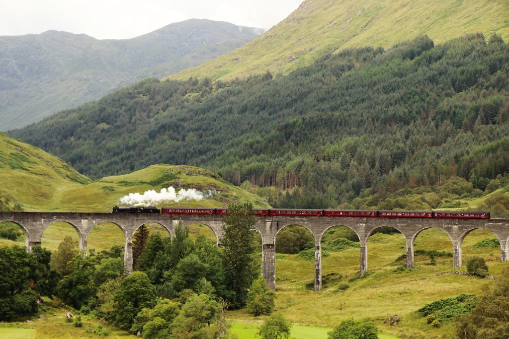 The Hogwarts Express crossing the Glenfinnan Viaduct in Scotland