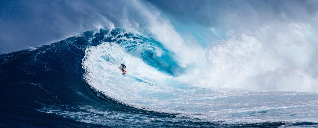 A surfer on a huge wave on the beaches of Hawaii