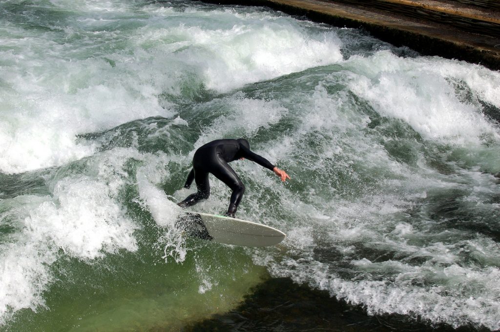 A surfer surfing the wave in the middle of Munich, a unique surf spot in the world