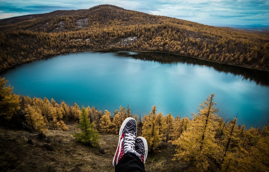 Feet with lake and mountains in the background
