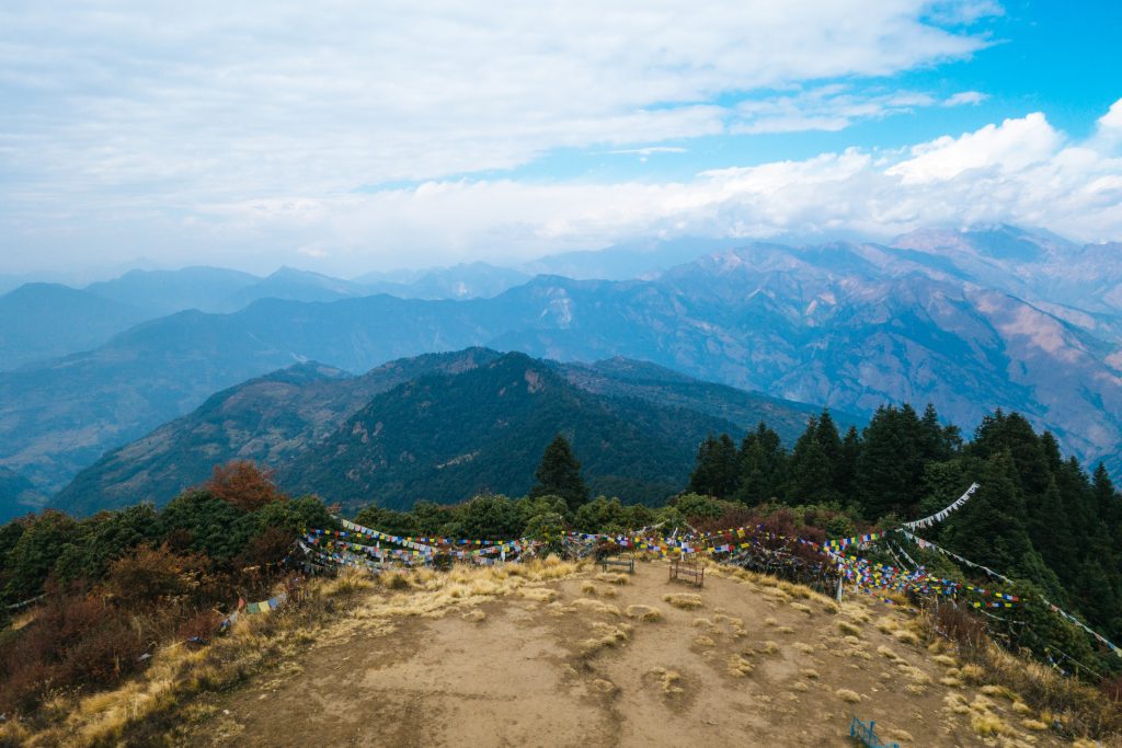 Poonhill in Nepal with a mountain view and colourful flags hanging,