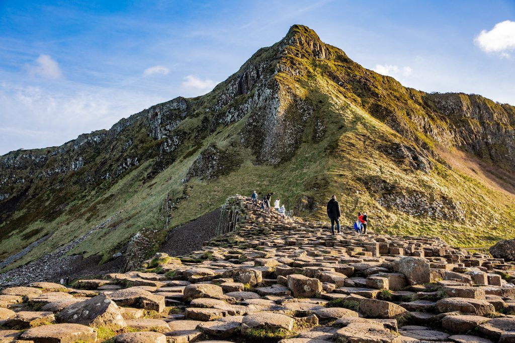 Giants Causeway on a sunny day with rolling hills in background