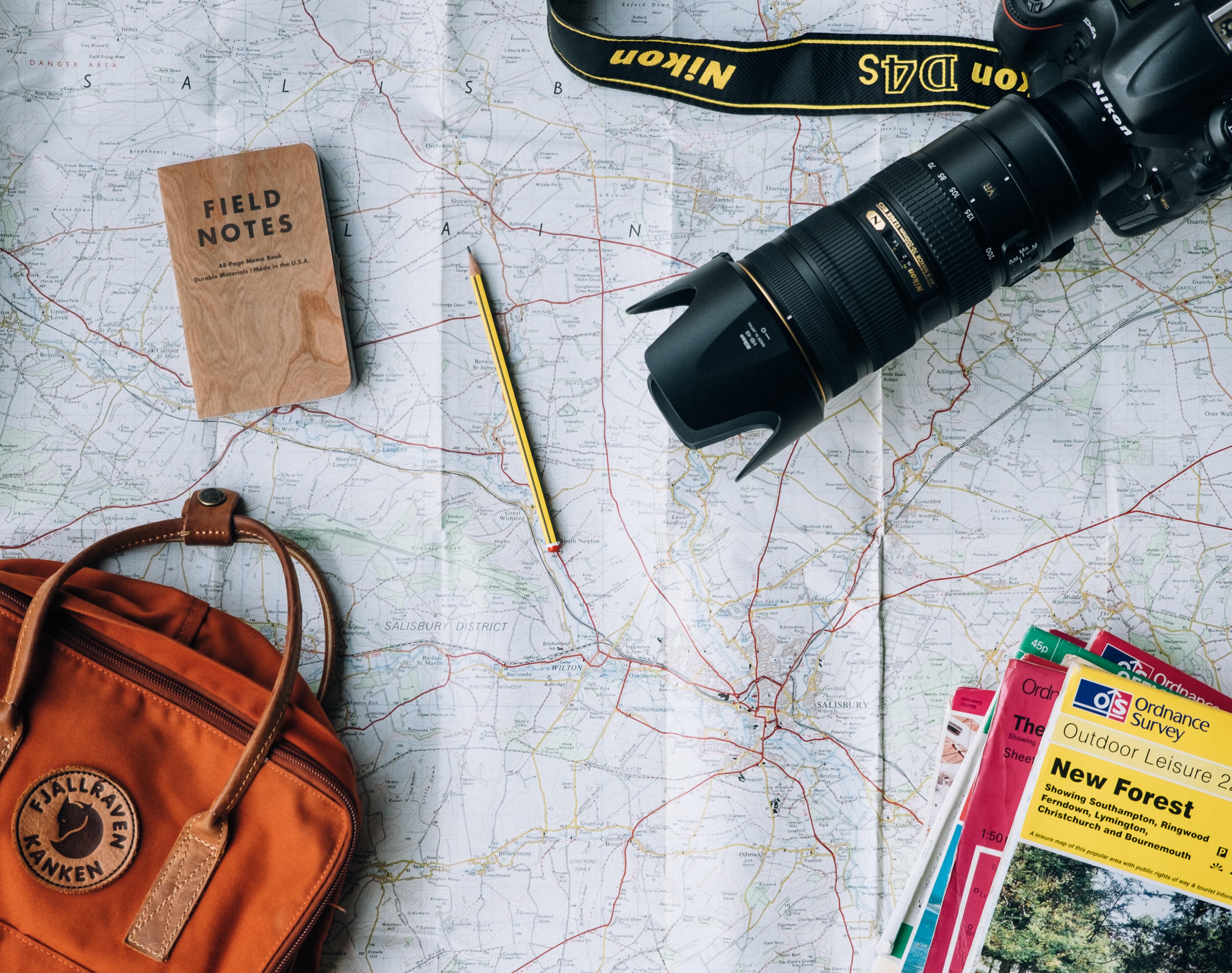 Travel essentials all laid on top of a map.
