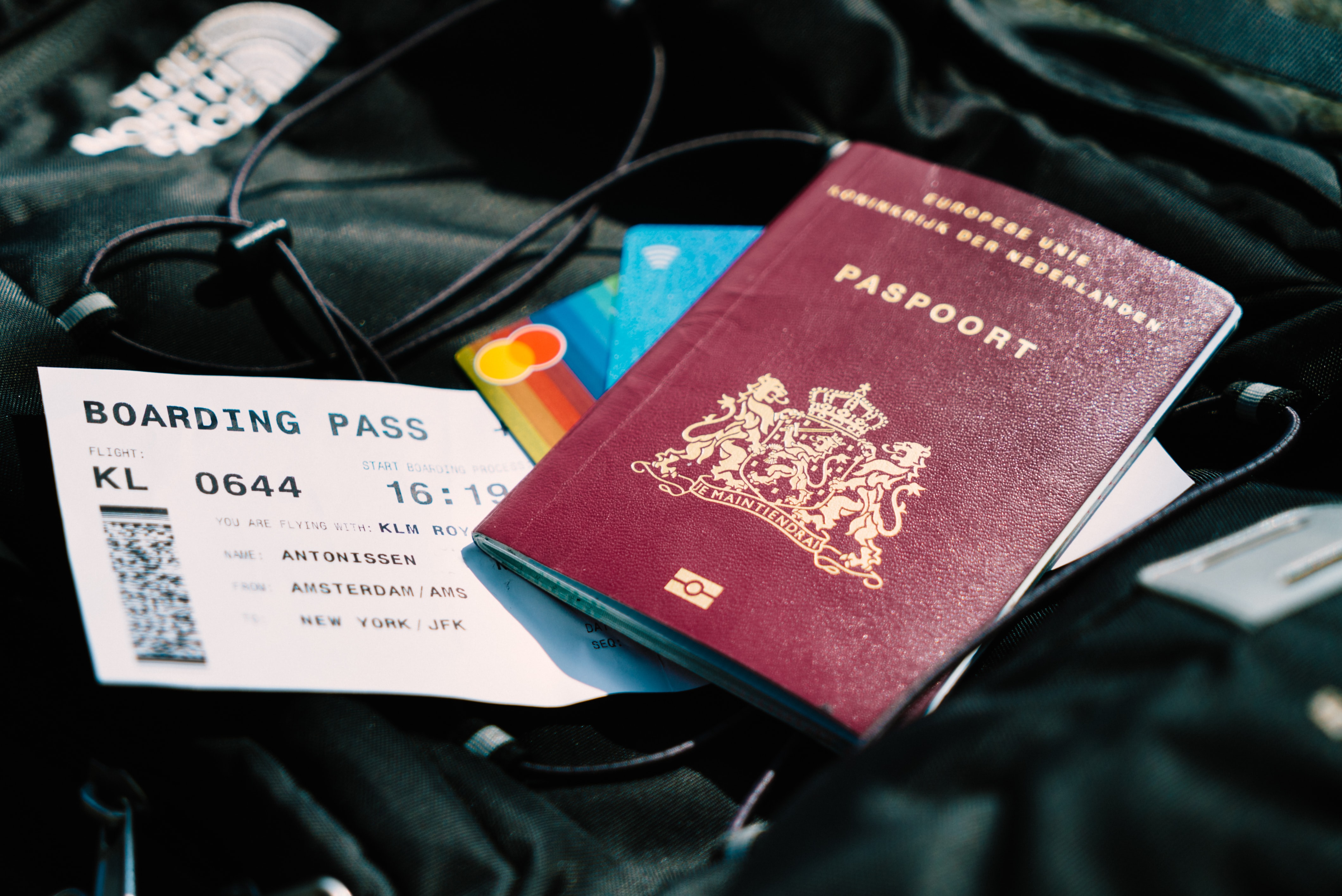 Travel documents on a black backpack