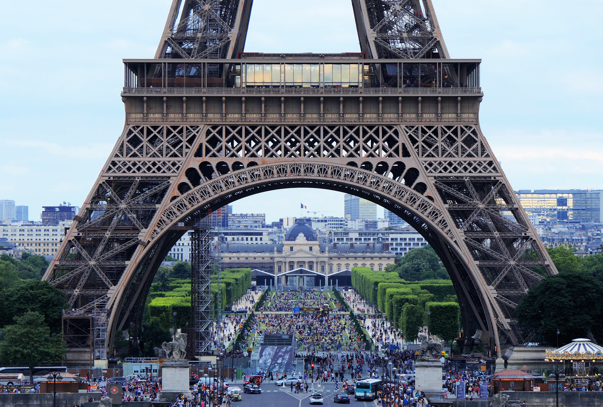 Crowds of people under the Eiffel Tower