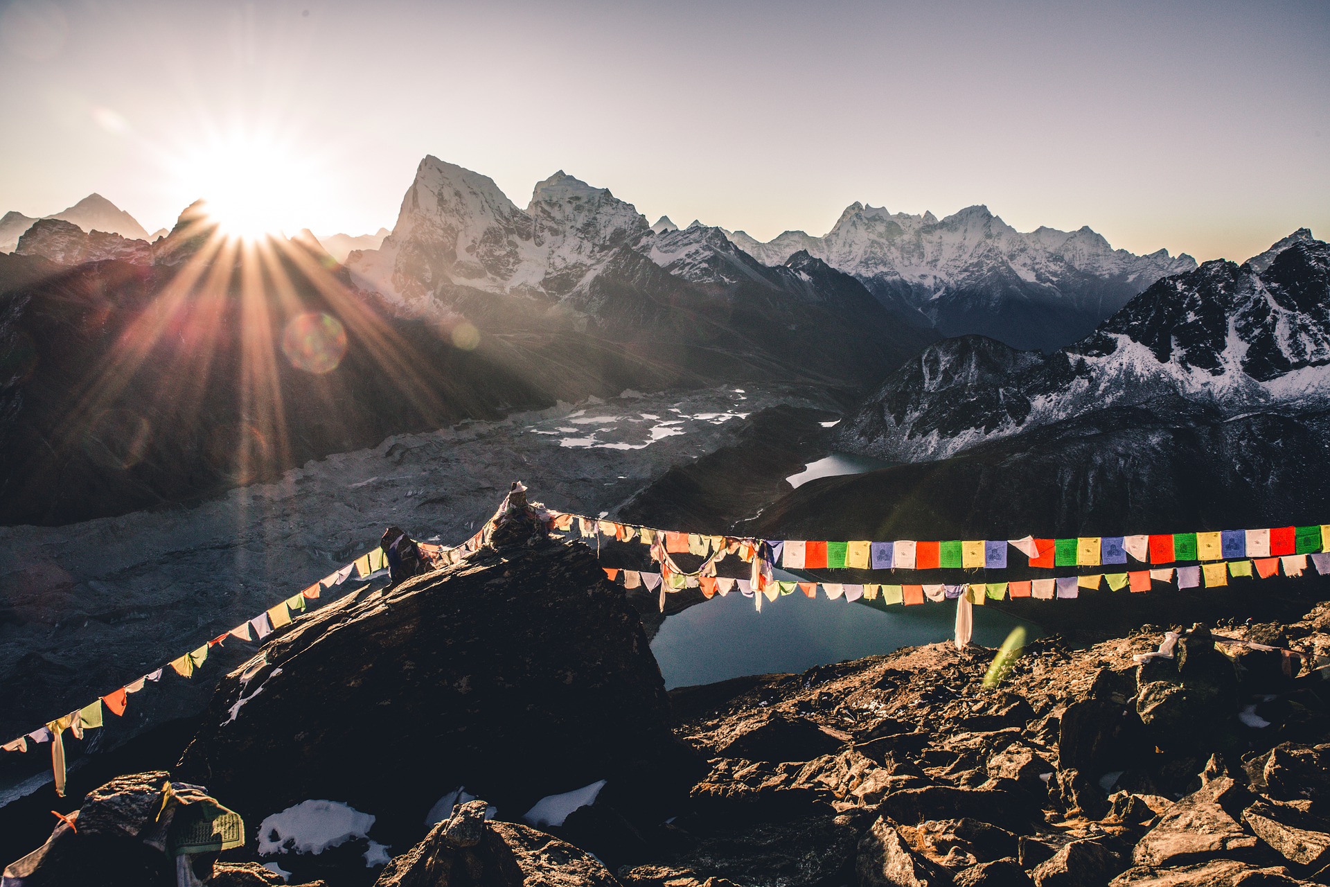 Flags at a summit at Mt Everest at sunrise