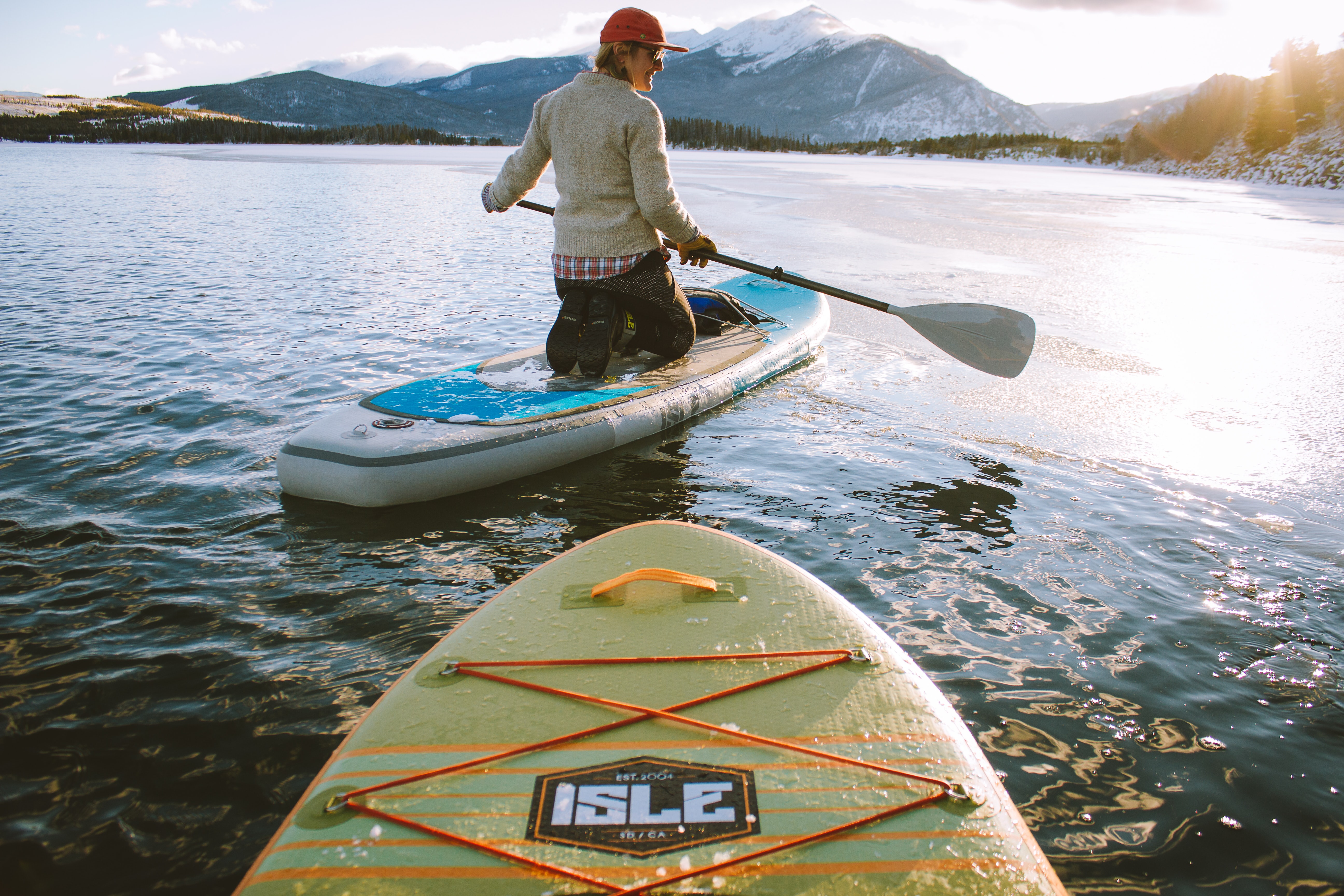 paddleboarding in the mountains at sunrise on a cold day