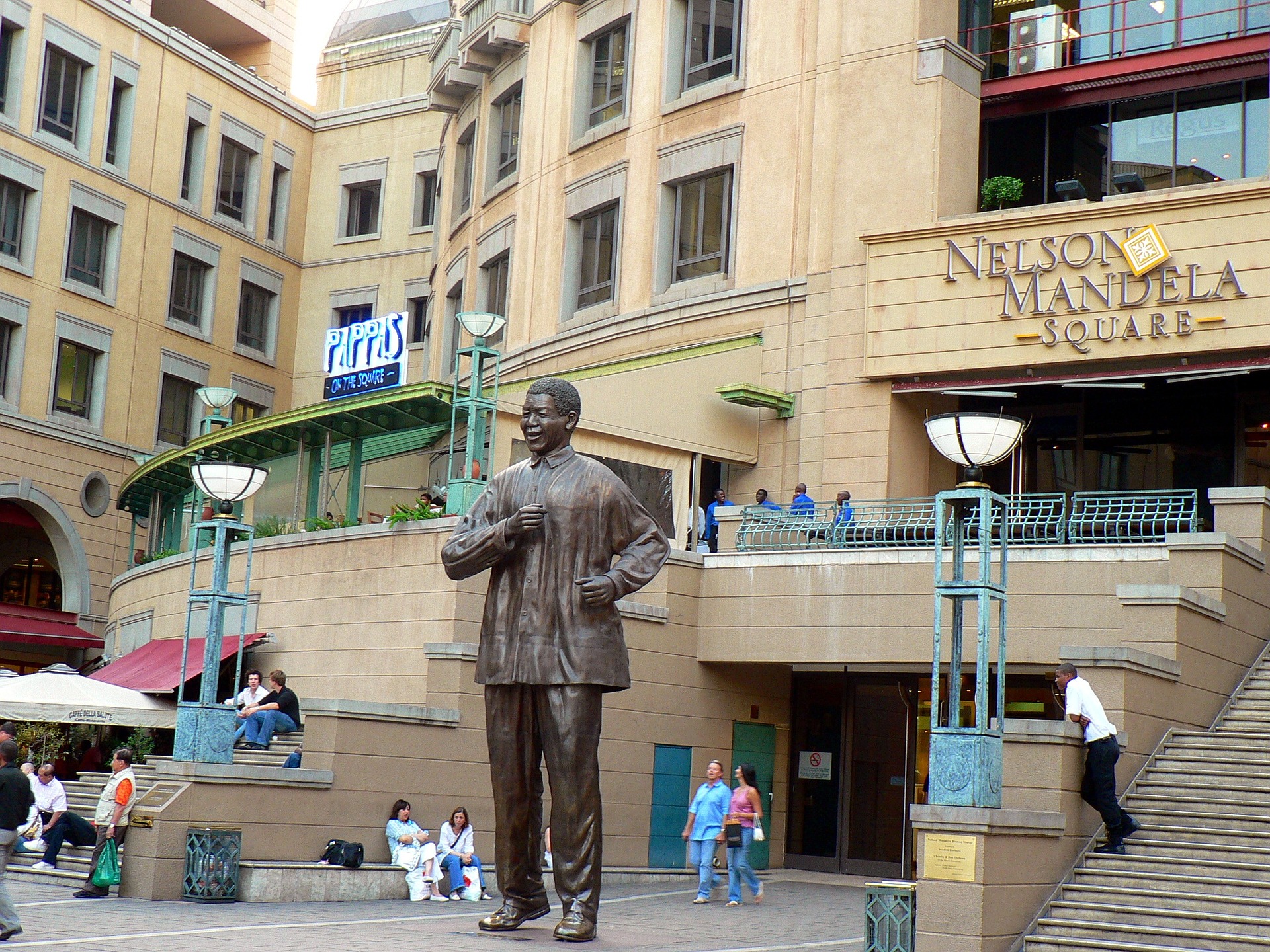 A large statue of Nelson Mandela surrounded by people in Johannesburg in South Africa