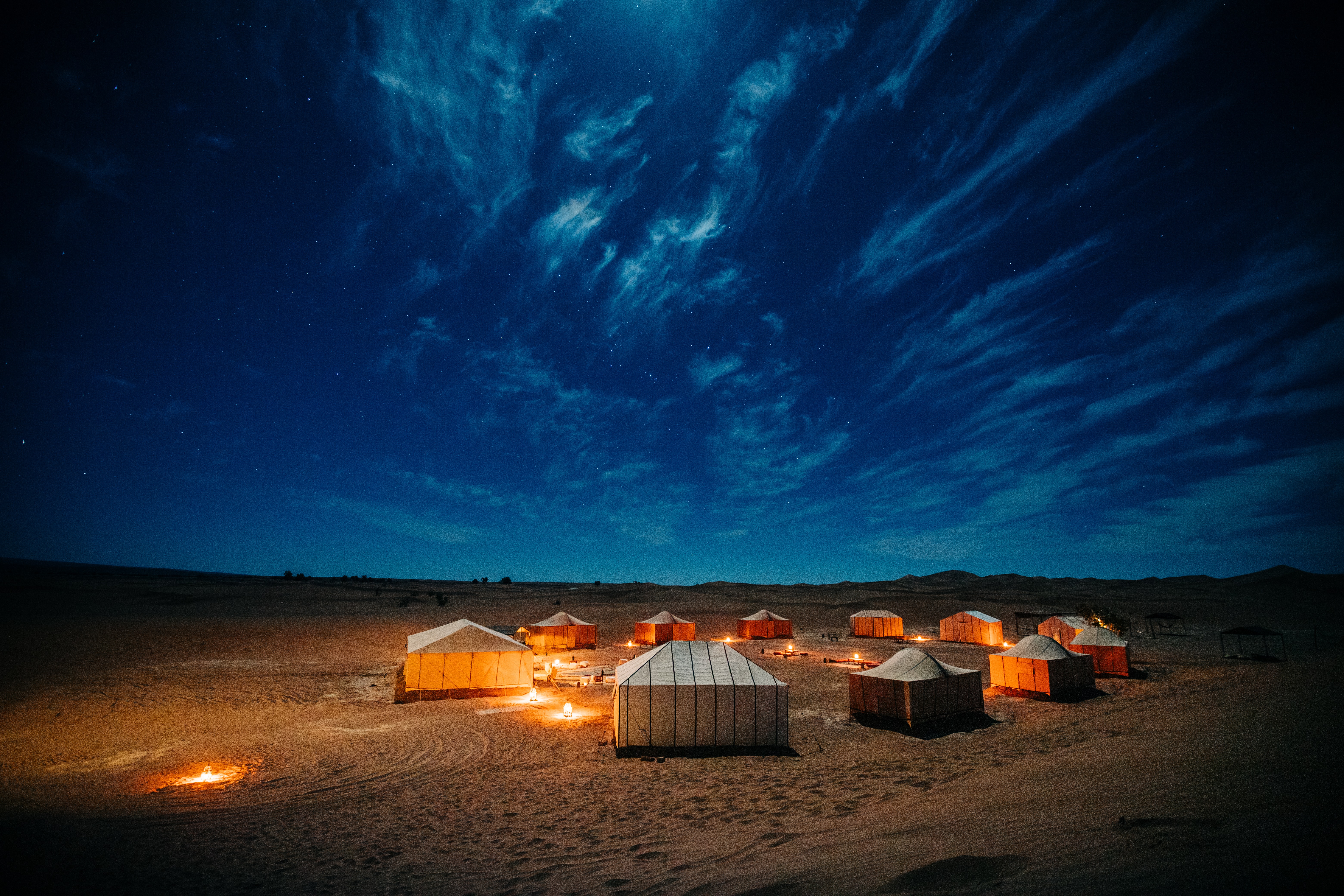A illuminated campground under night skies