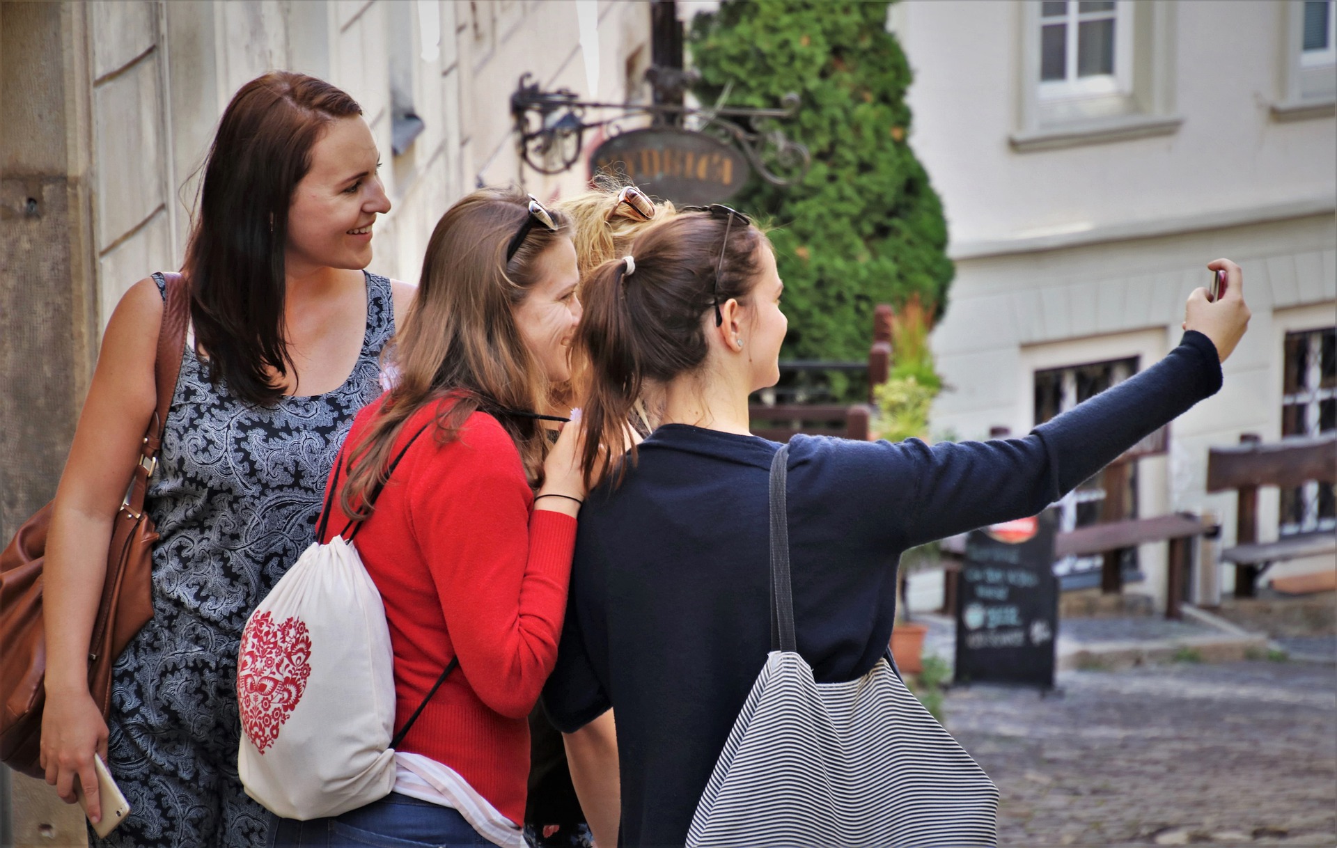Girls taking a selfie in an old town