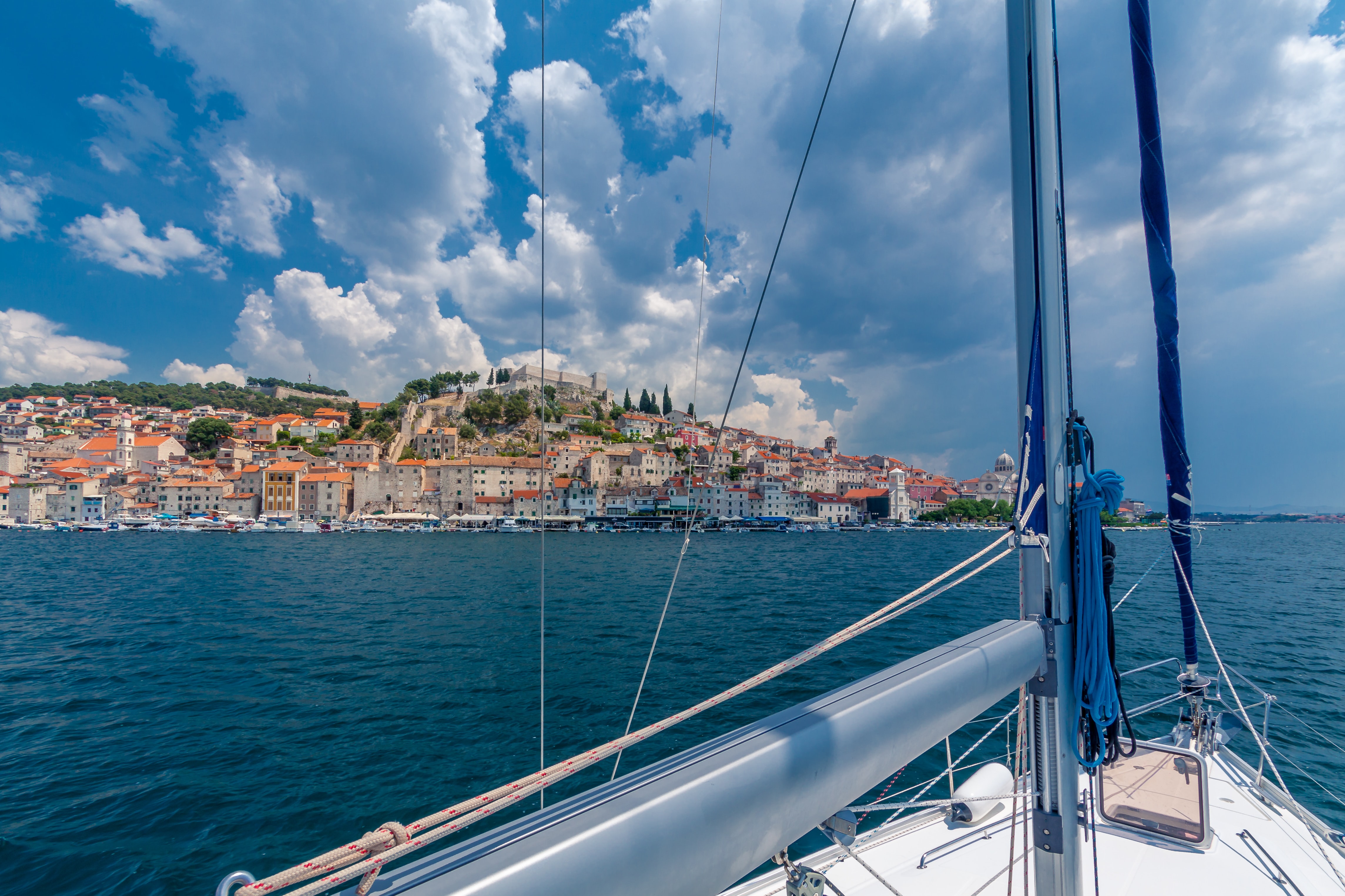 Sailing boat on the coast of Croatia with a view of a old town